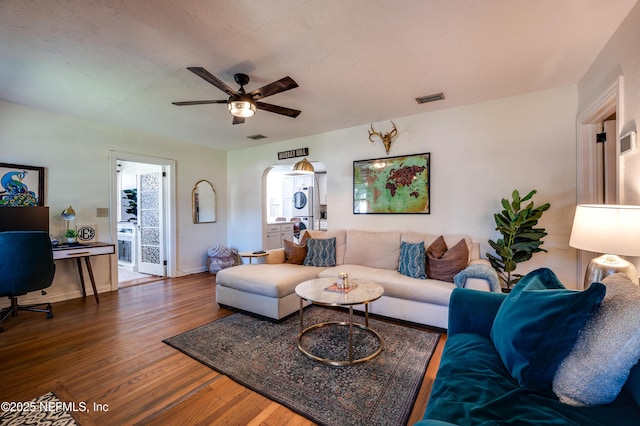 4818 Astral St, Jacksonville, FL 32205 - living room featuring a ceiling fan, wood finished floors, and arched walkways