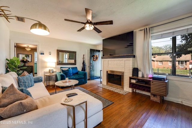 4818 Astral St, Jacksonville, FL 32205 - living room with a ceiling fan, wood finished floors, and a brick fireplace