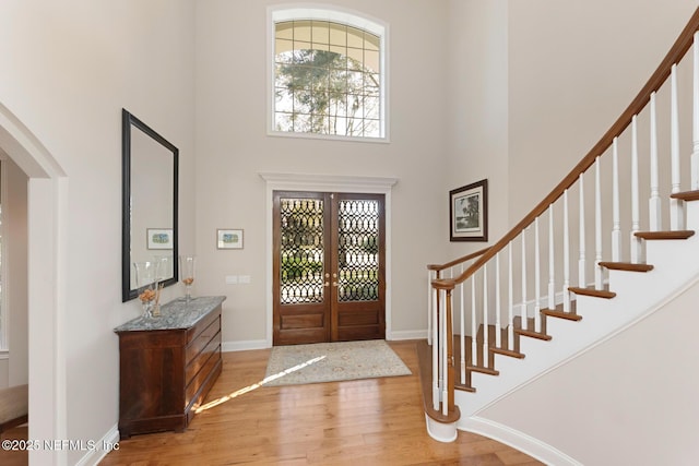 1614 Sheffield Park Ct, Jacksonville, FL 32225 - entrance foyer with a towering ceiling, wood finished floors, arched walkways, french doors, and stairway