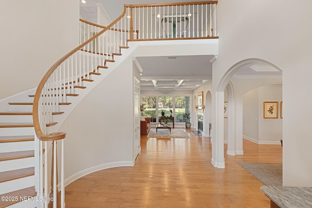 1614 Sheffield Park Ct, Jacksonville, FL 32225 - foyer entrance featuring wood finished floors, coffered ceiling, stairs, a high ceiling, and arched walkways