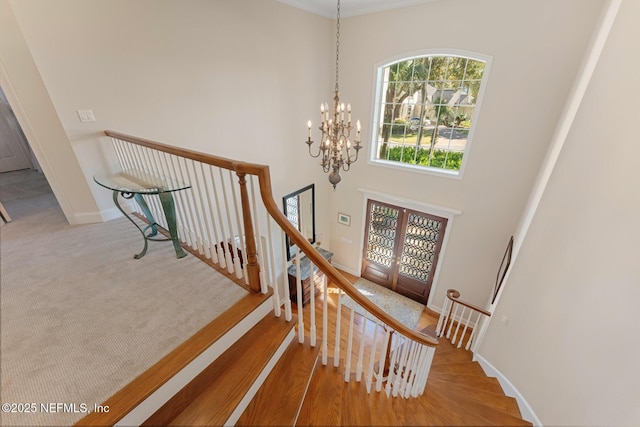 1614 Sheffield Park Ct, Jacksonville, FL 32225 - stairs featuring a towering ceiling, a chandelier, and french doors