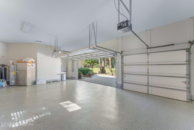 1614 Sheffield Park Ct, Jacksonville, FL 32225 - garage featuring freestanding refrigerator, a garage door opener, and electric water heater