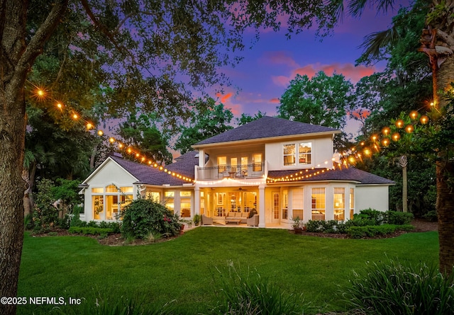 1614 Sheffield Park Ct, Jacksonville, FL 32225 - rear view of house with a balcony, an outdoor hangout area, stucco siding, and a lawn