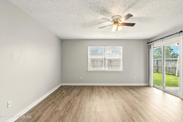 6719 Newgate Cir E, Jacksonville, FL 32244 - spare room with wood finished floors, ceiling fan, and a textured ceiling