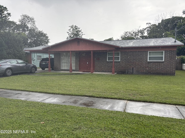 2584 Woolery Dr, Jacksonville, FL 32211 - ranch-style home featuring a front lawn and brick siding