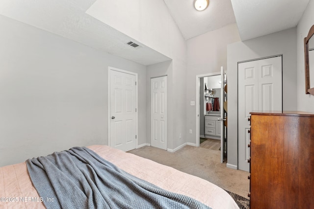 4737 College St, Jacksonville, FL 32205 - bedroom featuring light carpet, lofted ceiling, and ensuite bath
