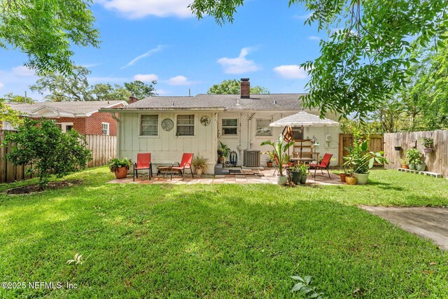 4737 College St, Jacksonville, FL 32205 - back of house featuring a chimney, a patio area, and a fenced backyard