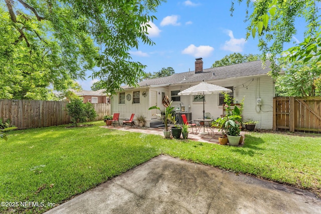 4737 College St, Jacksonville, FL 32205 - rear view of property with a chimney, a patio, a fenced backyard, and a shingled roof
