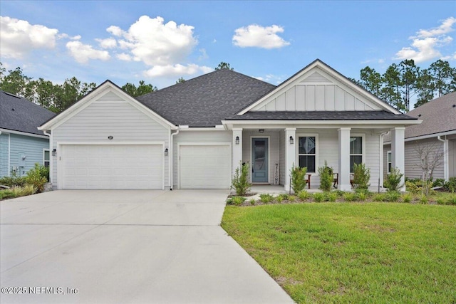 227 Wind Chime Ln, Saint Augustine, FL 32095 - view of front of house with an attached garage, a front yard, concrete driveway, a porch, and board and batten siding
