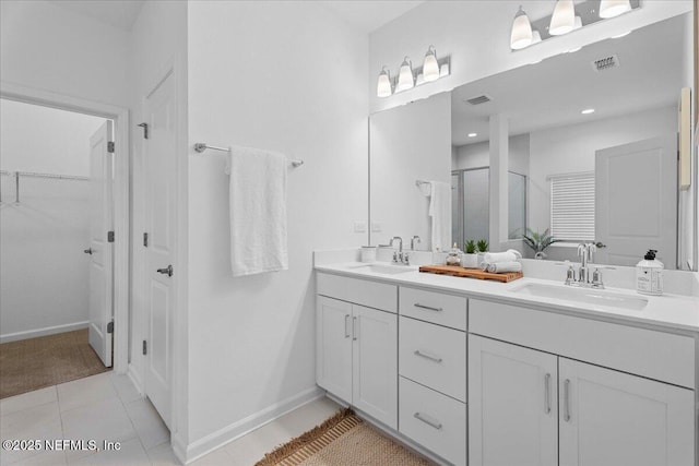 227 Wind Chime Ln, Saint Augustine, FL 32095 - full bath with double vanity, a stall shower, tile patterned floors, and a spacious closet