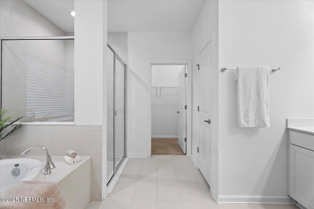 227 Wind Chime Ln, Saint Augustine, FL 32095 - bathroom with a shower stall, a bath, vanity, and a walk in closet