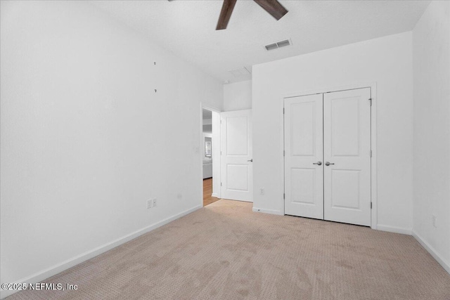 227 Wind Chime Ln, Saint Augustine, FL 32095 - unfurnished bedroom with carpet, a closet, and a ceiling fan