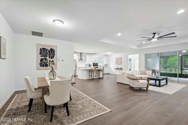 227 Wind Chime Ln, Saint Augustine, FL 32095 - dining area with dark wood-style flooring, recessed lighting, ceiling fan, and a textured ceiling