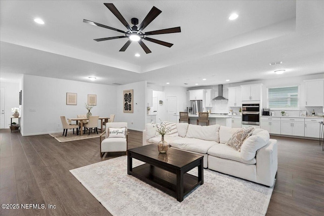 227 Wind Chime Ln, Saint Augustine, FL 32095 - living room with a raised ceiling, ceiling fan, dark wood finished floors, and recessed lighting