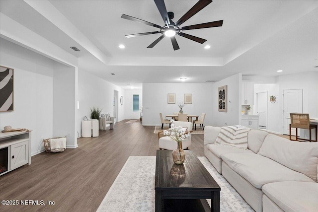 227 Wind Chime Ln, Saint Augustine, FL 32095 - living room featuring a raised ceiling, a ceiling fan, wood finished floors, and recessed lighting
