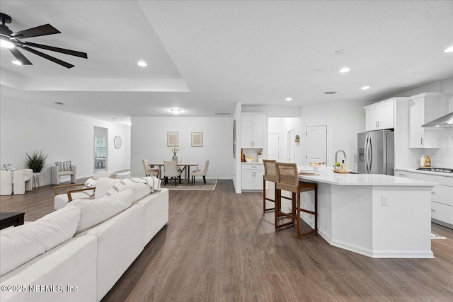 227 Wind Chime Ln, Saint Augustine, FL 32095 - living area featuring recessed lighting, dark wood-style floors, ceiling fan, and a raised ceiling