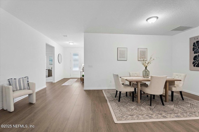 227 Wind Chime Ln, Saint Augustine, FL 32095 - dining area featuring wood finished floors and a textured ceiling
