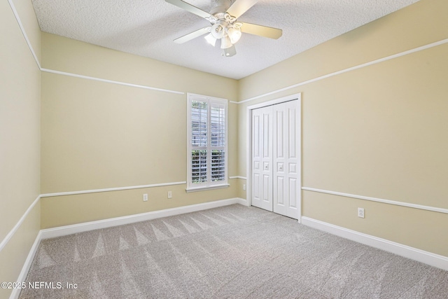 1028 Meadow View Ln, Saint Augustine, FL 32092 - unfurnished bedroom featuring carpet, a textured ceiling, a closet, and ceiling fan