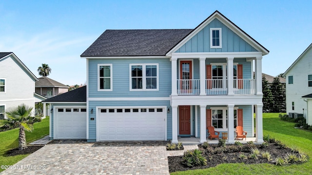 62 Seaside Vista Ct, Saint Augustine, FL 32084 - view of front of property with covered porch, board and batten siding, a balcony, and driveway