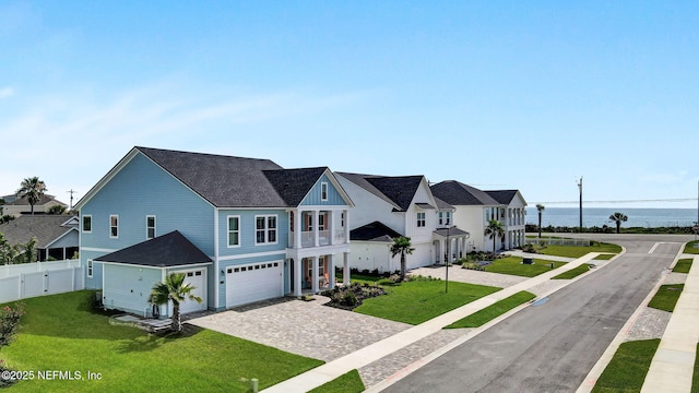 62 Seaside Vista Ct, Saint Augustine, FL 32084 - view of front of home featuring a garage, decorative driveway, a water view, a residential view, and a shingled roof