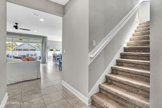 62 Seaside Vista Ct, Saint Augustine, FL 32084 - stairway featuring ceiling fan, tile patterned floors, recessed lighting, and a textured wall
