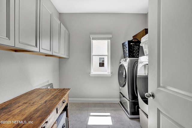 62 Seaside Vista Ct, Saint Augustine, FL 32084 - washroom with washer and clothes dryer, light tile patterned floors, and cabinet space
