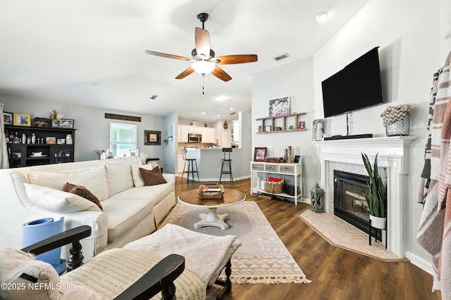 145 E Blackjack Branch Way, Saint Johns, FL 32259 - living area with a ceiling fan, a fireplace, dark wood finished floors, and vaulted ceiling