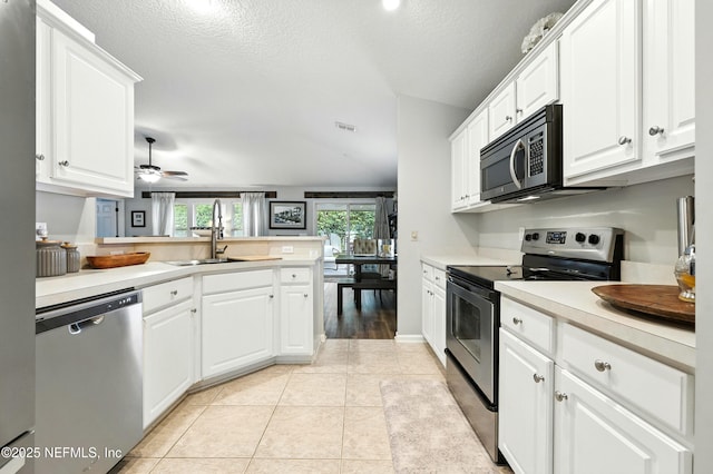 145 E Blackjack Branch Way, Saint Johns, FL 32259 - kitchen with appliances with stainless steel finishes, white cabinetry, light countertops, and a textured ceiling