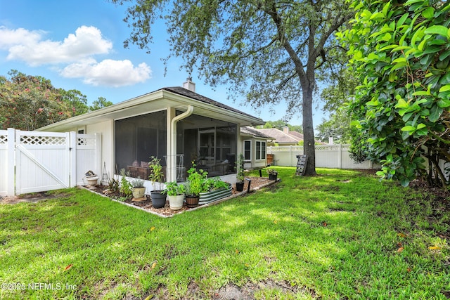 145 E Blackjack Branch Way, Saint Johns, FL 32259 - view of home's exterior featuring a gate, a fenced backyard, a sunroom, and a chimney