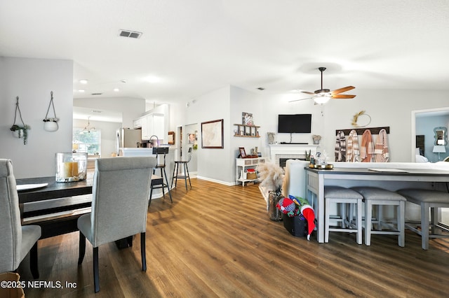 145 E Blackjack Branch Way, Saint Johns, FL 32259 - dining space featuring vaulted ceiling, dark wood-style floors, ceiling fan, recessed lighting, and a fireplace