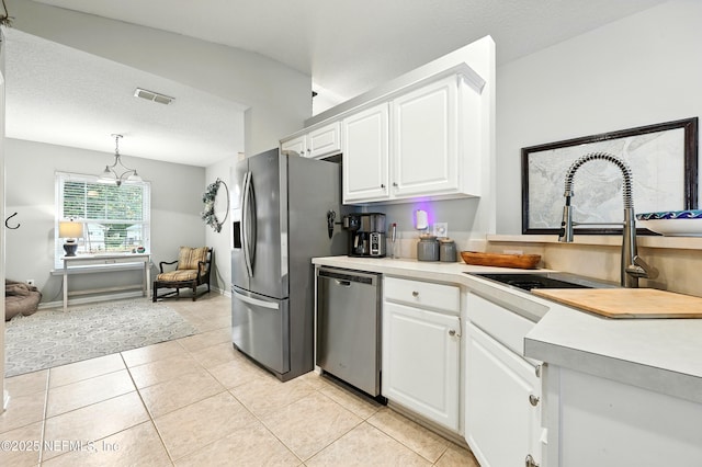 145 E Blackjack Branch Way, Saint Johns, FL 32259 - kitchen featuring stainless steel appliances, white cabinets, light countertops, light tile patterned floors, and decorative light fixtures