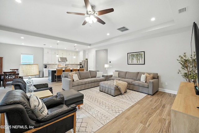 214 Gap Creek Dr, Saint Johns, FL 32259 - living room featuring a ceiling fan, a raised ceiling, recessed lighting, and light wood finished floors