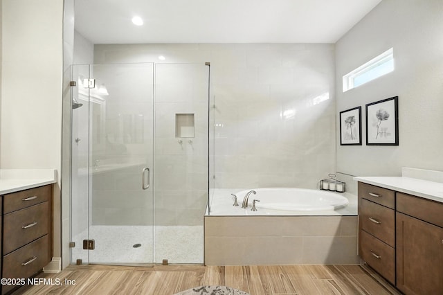 214 Gap Creek Dr, Saint Johns, FL 32259 - full bathroom with vanity, a garden tub, a shower stall, and wood finished floors