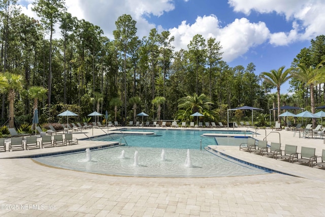214 Gap Creek Dr, Saint Johns, FL 32259 - community pool featuring a patio area and view of wooded area