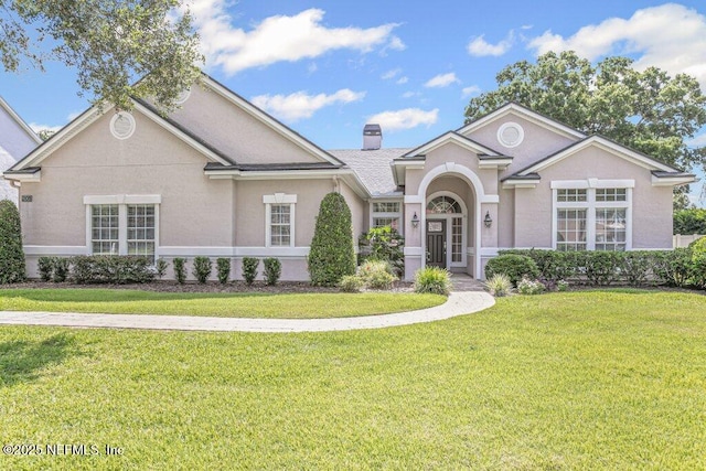 205 N Checkerberry Way, Saint Johns, FL 32259 - view of front of property featuring a front yard, stucco siding, and a chimney