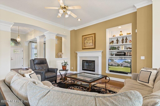 205 N Checkerberry Way, Saint Johns, FL 32259 - living area featuring ornate columns, ceiling fan, ornamental molding, a tiled fireplace, and arched walkways