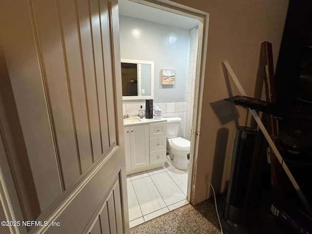 511 Clearview Dr, Cocoa, FL 32927 - bathroom featuring tile walls, vanity, and a wainscoted wall