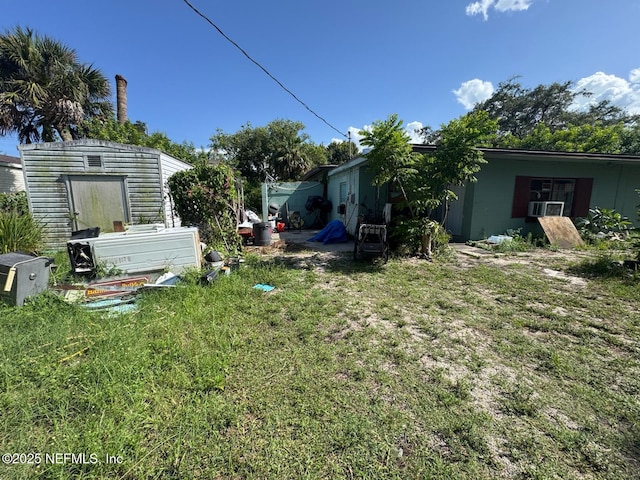 511 Clearview Dr, Cocoa, FL 32927 - view of grassy yard with a storage unit and cooling unit