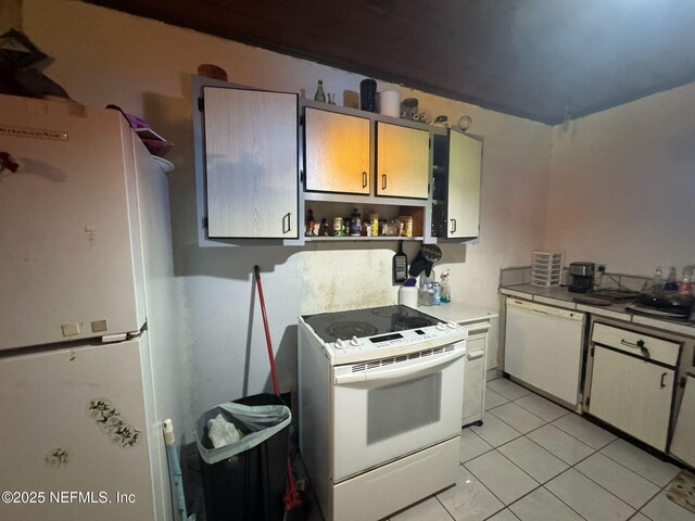 511 Clearview Dr, Cocoa, FL 32927 - kitchen with white appliances, light tile patterned flooring, and open shelves