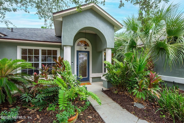 213 Seamist Ct, Ponte Vedra Beach, FL 32082 - view of exterior entry featuring stucco siding and a shingled roof