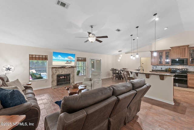 213 Seamist Ct, Ponte Vedra Beach, FL 32082 - living room with a high end fireplace, vaulted ceiling, light wood finished floors, and ceiling fan