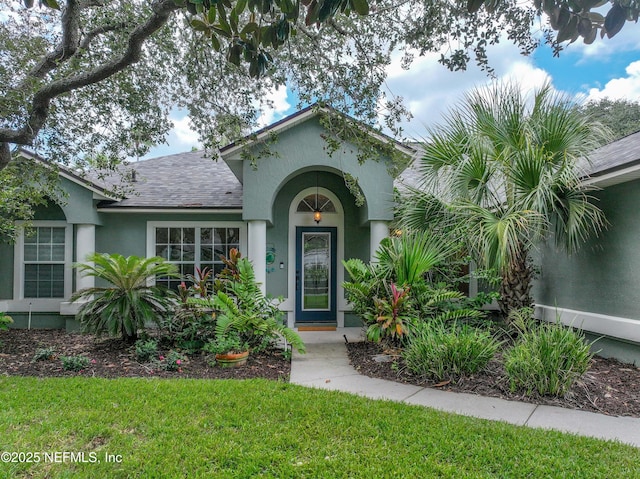 213 Seamist Ct, Ponte Vedra Beach, FL 32082 - view of front facade with stucco siding, a front yard, and a shingled roof