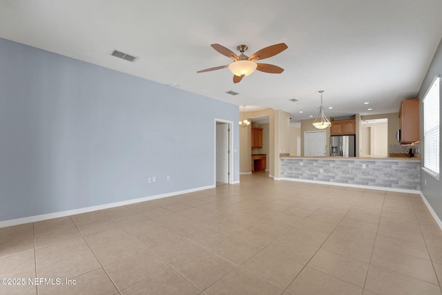 25122 Chipshot Ct, Sorrento, FL 32776 - unfurnished living room featuring a chandelier, ceiling fan, and light tile patterned floors