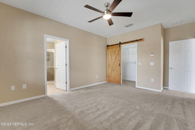25122 Chipshot Ct, Sorrento, FL 32776 - unfurnished bedroom featuring carpet floors, a barn door, a spacious closet, a closet, and a ceiling fan