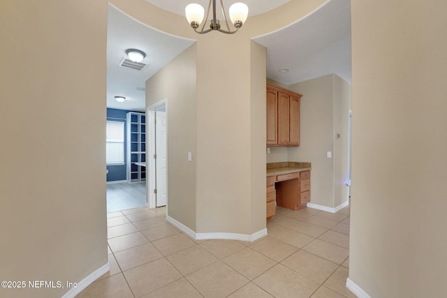 25122 Chipshot Ct, Sorrento, FL 32776 - hall with light tile patterned flooring, a desk, and a chandelier