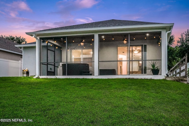 25122 Chipshot Ct, Sorrento, FL 32776 - back of house with a lawn, stucco siding, and a sunroom