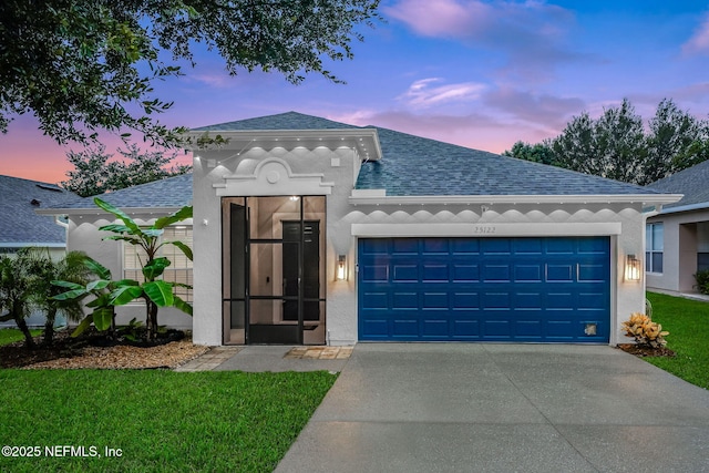 25122 Chipshot Ct, Sorrento, FL 32776 - view of front of house with a shingled roof, a garage, concrete driveway, and stucco siding