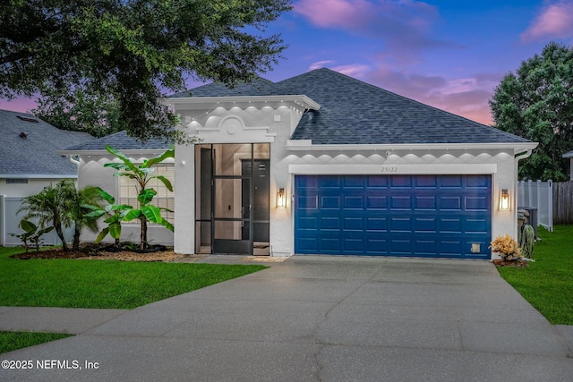 25122 Chipshot Ct, Sorrento, FL 32776 - view of front facade featuring roof with shingles, driveway, a garage, and stucco siding