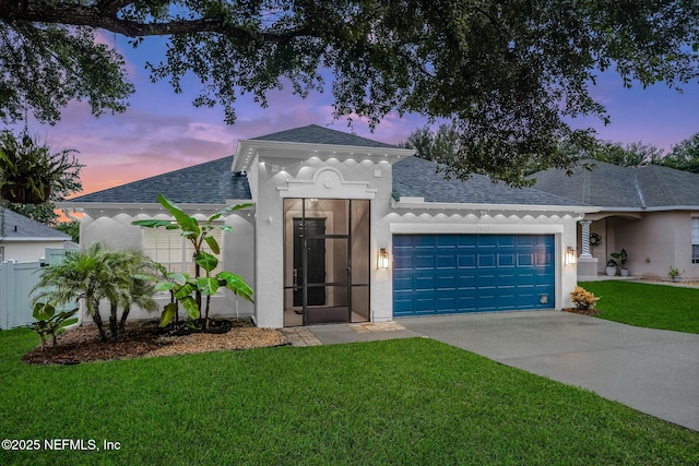 25122 Chipshot Ct, Sorrento, FL 32776 - view of front facade with roof with shingles, an attached garage, driveway, and stucco siding