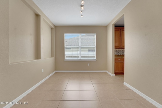 25122 Chipshot Ct, Sorrento, FL 32776 - unfurnished dining area featuring light tile patterned floors and track lighting